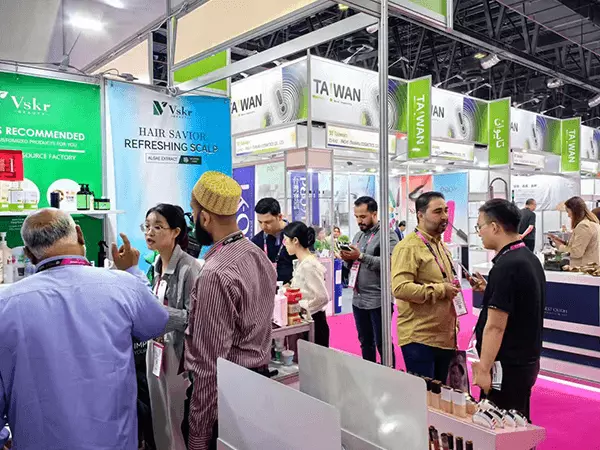 Una fábrica de gel de ducha en Guangzhou posa para una foto con clientes en una exposición.